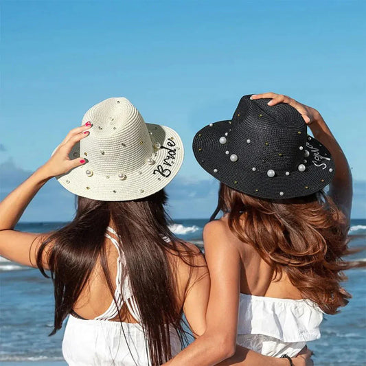 Two women wearing personalized custom sun hats with pearl embellishments at the beach - custom summer accessories from Bella Olivia Gifts