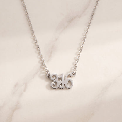Custom Bible Verse Number Necklace, flat lay of the silver 3:16 verse necklace
