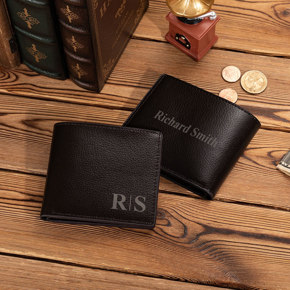 Two black wallets engraved with initials and a full name