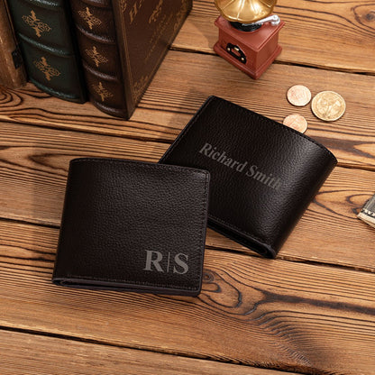 Two black wallets engraved with initials and a full name