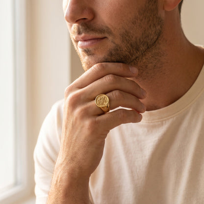 Family signet ring on a man's hand at his jaw