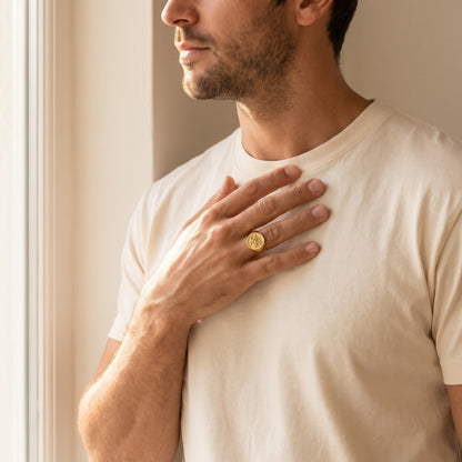 Man wearing the family signet ring, hand on chest